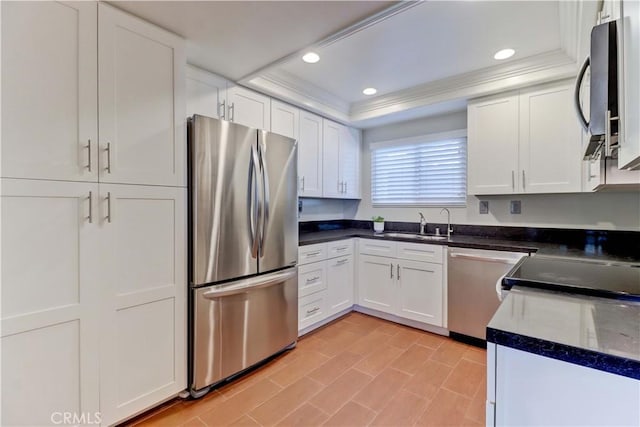 5371 Punta Alta Unit 2G, Laguna Woods, CA 92637 - kitchen with appliances with stainless steel finishes, a tray ceiling, white cabinetry, recessed lighting, and dark countertops