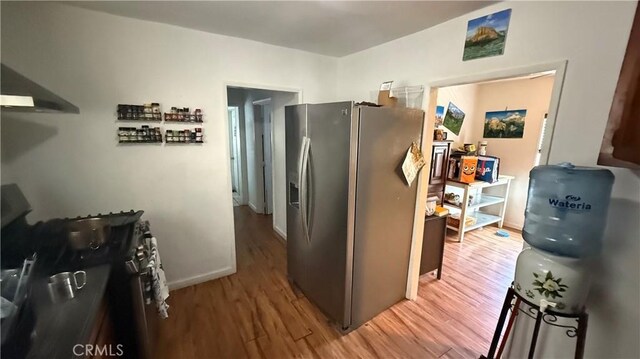 10218 Virginia Ave, South Gate, CA 90280 - kitchen with stainless steel refrigerator with ice dispenser, wood finished floors, and black range with gas cooktop