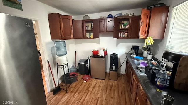 10218 Virginia Ave, South Gate, CA 90280 - kitchen with freestanding refrigerator, open shelves, and light wood-style floors