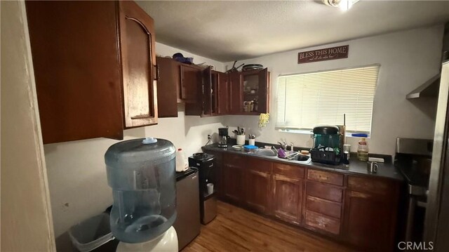 10218 Virginia Ave, South Gate, CA 90280 - kitchen featuring wood finished floors and dark countertops