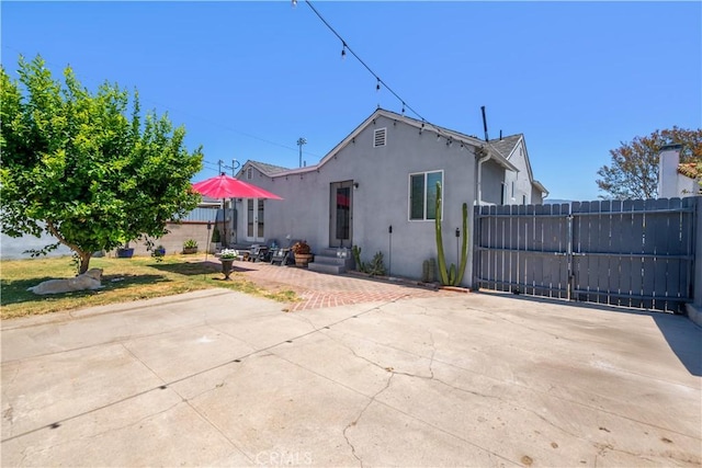 321 N Keystone St, Burbank, CA 91506 - view of front of house with stucco siding, entry steps, a patio area, and a gate