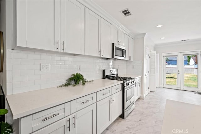 321 N Keystone St, Burbank, CA 91506 - kitchen featuring appliances with stainless steel finishes, crown molding, light marble finish floors, white cabinets, and decorative backsplash