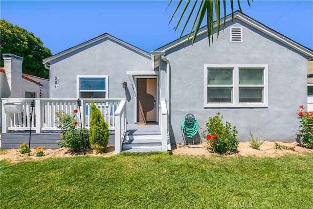 321 N Keystone St, Burbank, CA 91506 - view of front of property featuring a deck, stucco siding, and a front lawn