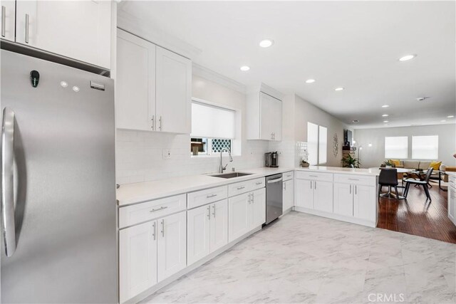 321 N Keystone St, Burbank, CA 91506 - kitchen featuring stainless steel appliances, white cabinetry, tasteful backsplash, recessed lighting, and light countertops