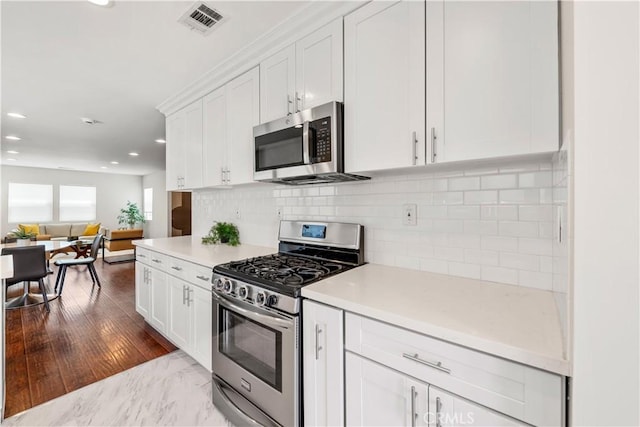 321 N Keystone St, Burbank, CA 91506 - kitchen with appliances with stainless steel finishes, white cabinetry, recessed lighting, light countertops, and open floor plan