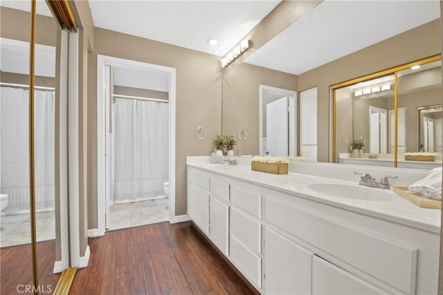 10361 Garden Grove Blvd Unit 17, Garden Grove, CA 92843 - bathroom featuring double vanity, hardwood / wood-style flooring, recessed lighting, and a shower with shower curtain