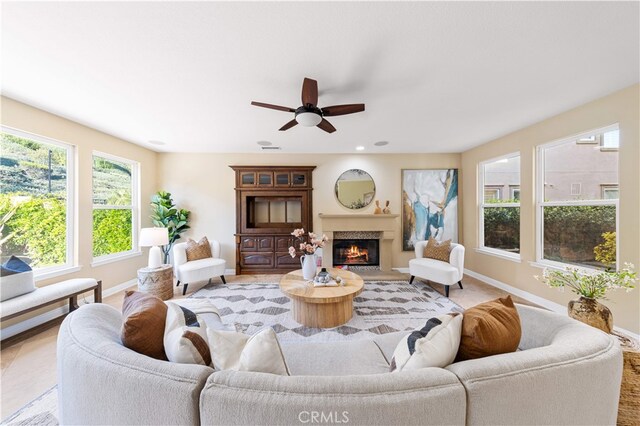 27684 Manor Hill Rd, Laguna Niguel, CA 92677 - living room featuring a warm lit fireplace and a ceiling fan