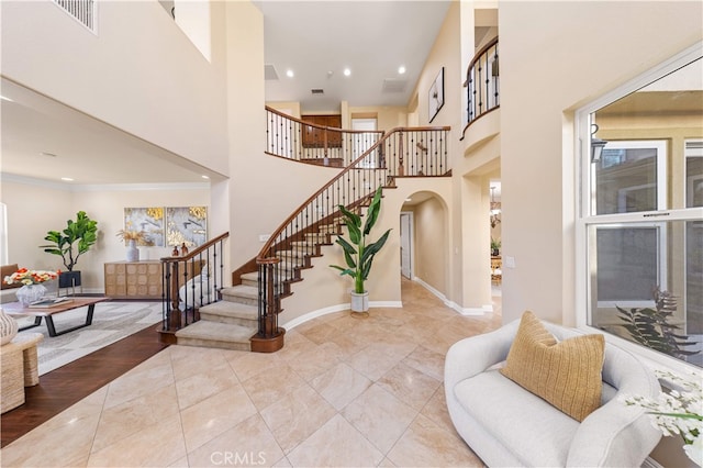 27684 Manor Hill Rd, Laguna Niguel, CA 92677 - tiled entryway with arched walkways, stairs, recessed lighting, a towering ceiling, and crown molding