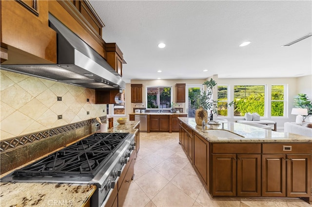 27684 Manor Hill Rd, Laguna Niguel, CA 92677 - kitchen featuring wall chimney range hood, appliances with stainless steel finishes, light stone counters, decorative backsplash, and recessed lighting