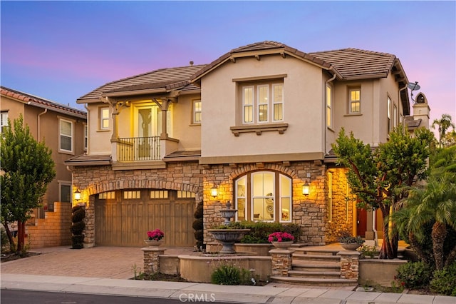 27684 Manor Hill Rd, Laguna Niguel, CA 92677 - mediterranean / spanish home featuring stone siding, stucco siding, an attached garage, and decorative driveway