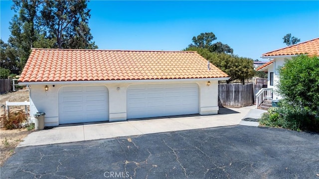 2911 Gilead Ln, Paso Robles, CA 93446 - view of front facade with stucco siding, a tiled roof, and a garage