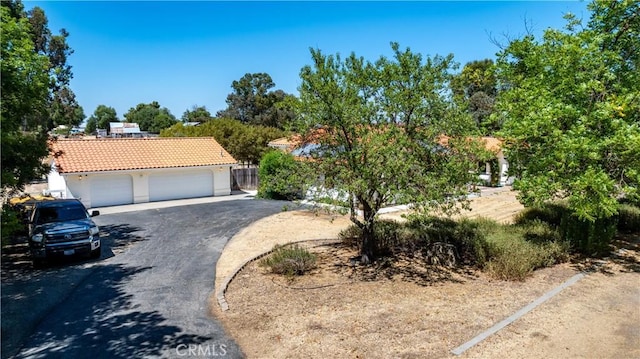 2911 Gilead Ln, Paso Robles, CA 93446 - obstructed view of property featuring a tile roof, stucco siding, and a detached garage