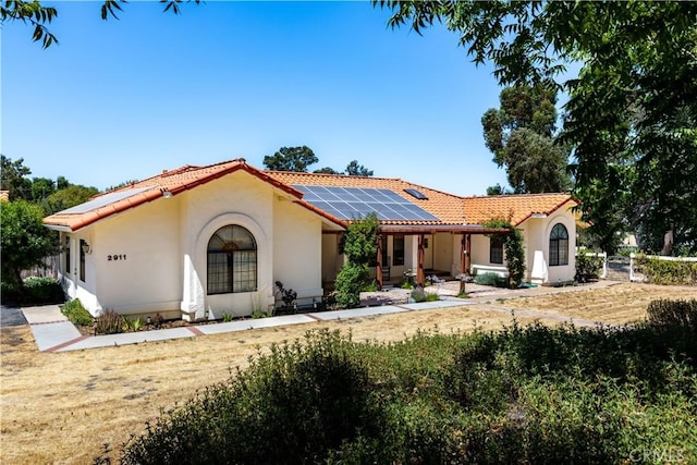 2911 Gilead Ln, Paso Robles, CA 93446 - mediterranean / spanish house featuring a tiled roof, roof mounted solar panels, and stucco siding