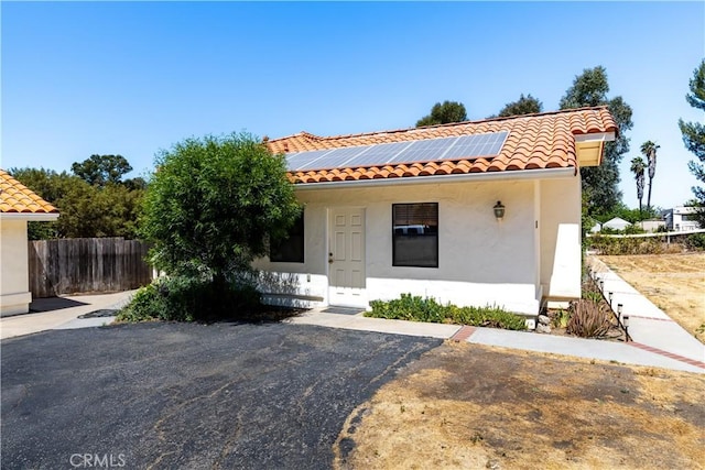 2911 Gilead Ln, Paso Robles, CA 93446 - mediterranean / spanish-style home with a tiled roof, solar panels, and stucco siding
