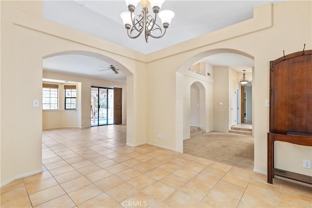2911 Gilead Ln, Paso Robles, CA 93446 - spare room featuring arched walkways, a chandelier, light tile patterned floors, light carpet, and a ceiling fan