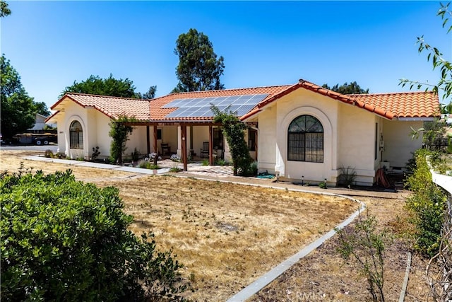 2911 Gilead Ln, Paso Robles, CA 93446 - mediterranean / spanish-style home featuring a tiled roof, solar panels, and stucco siding
