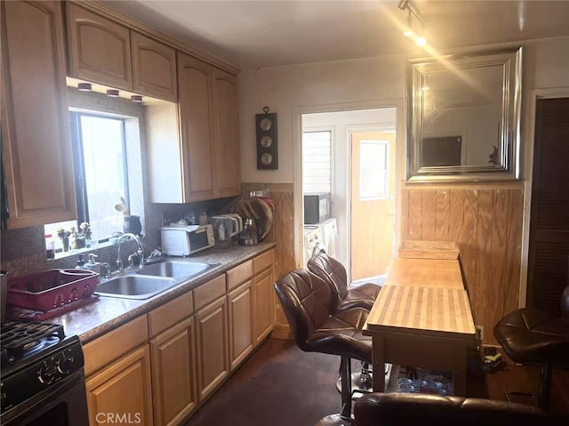 934 W 12th St, Pomona, CA 91766 - kitchen with washer and clothes dryer, black gas range, stainless steel microwave, white microwave, and tasteful backsplash