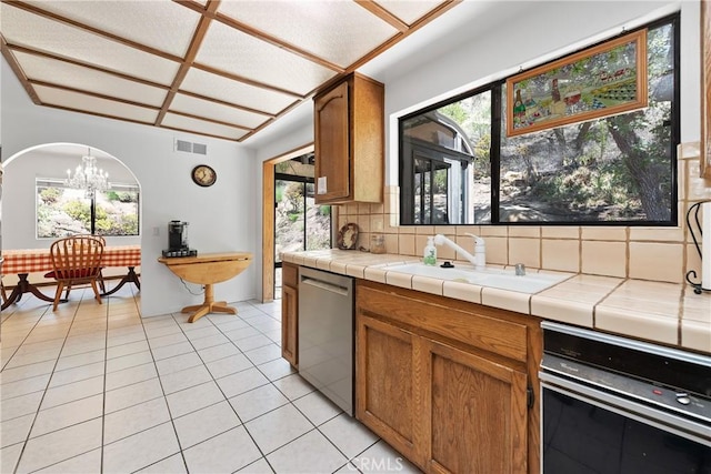 9349 Hartman Way, West Hills, CA 91304 - kitchen with stainless steel dishwasher, a chandelier, decorative backsplash, light tile patterned floors, and healthy amount of natural light