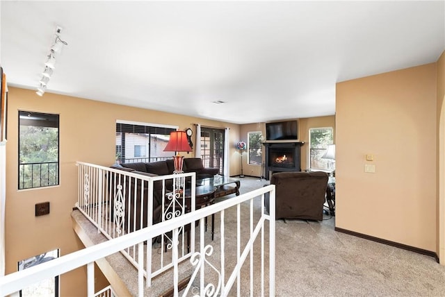 9349 Hartman Way, West Hills, CA 91304 - living room featuring track lighting, carpet floors, and a lit fireplace