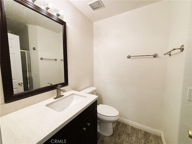 493 Hillsborough Way, Corona, CA 92879 - bathroom featuring vanity, wood finished floors, a shower with door, a textured wall, and a textured ceiling
