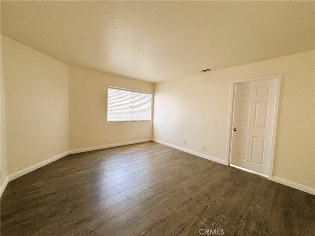 493 Hillsborough Way, Corona, CA 92879 - spare room featuring dark wood-style flooring and baseboards