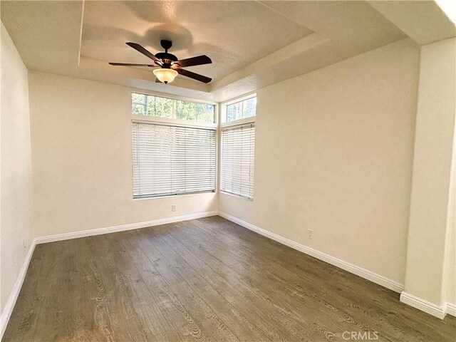 493 Hillsborough Way, Corona, CA 92879 - unfurnished room featuring a tray ceiling, dark wood-style flooring, and a ceiling fan