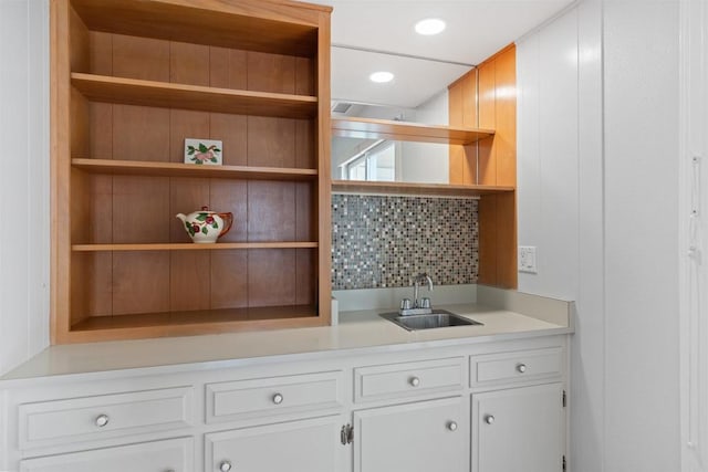 3621 Vista Campana S Unit 54, Oceanside, CA 92057 - kitchen featuring open shelves, light countertops, white cabinets, and tasteful backsplash