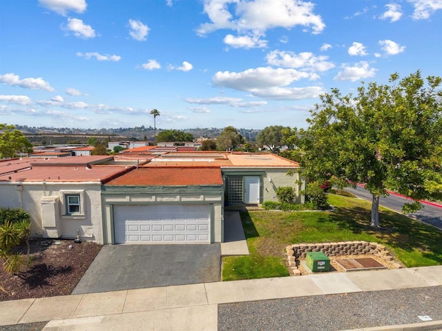 3621 Vista Campana S Unit 54, Oceanside, CA 92057 - view of front of home with asphalt driveway, stucco siding, a front yard, and a garage