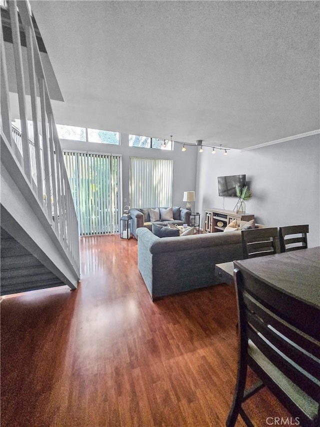 10659 Lakefront Dr, Norwalk, CA 90650 - living area with wood finished floors, rail lighting, and a textured ceiling