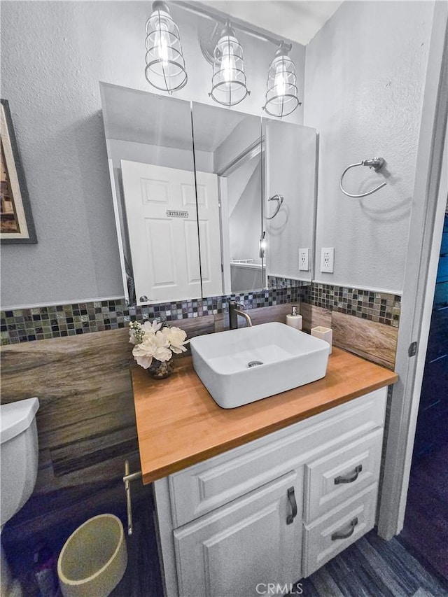 10659 Lakefront Dr, Norwalk, CA 90650 - bathroom with vanity, decorative backsplash, and a textured wall