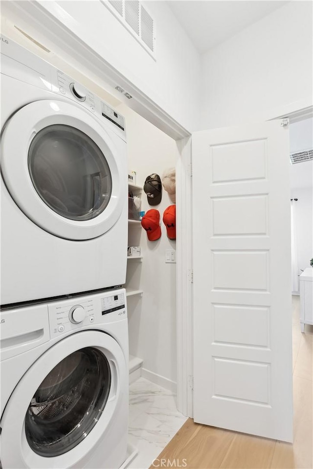 2371 Horseback Rd, Rancho Mission Viejo, CA 92694 - laundry area featuring estacked washer and dryer and light marble finish flooring