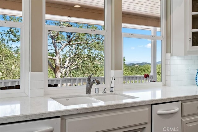 6600 San Gabriel Rd, Atascadero, CA 93422 - kitchen with dishwasher, decorative backsplash, light stone countertops, white cabinets, and a mountain view