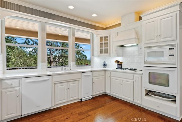 6600 San Gabriel Rd, Atascadero, CA 93422 - kitchen with white appliances, decorative backsplash, white cabinets, dark wood-style flooring, and crown molding
