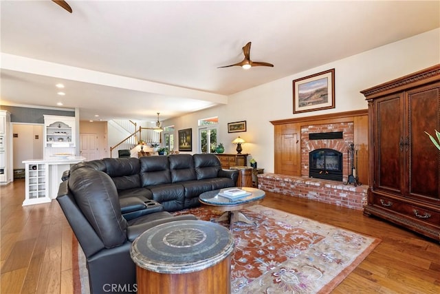 6600 San Gabriel Rd, Atascadero, CA 93422 - living room with a ceiling fan, wood-type flooring, a brick fireplace, stairs, and recessed lighting