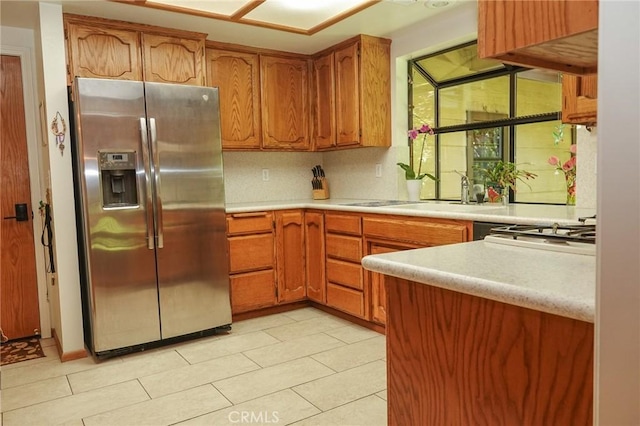 2787 Grape Way, Chico, CA 95973 - kitchen featuring stainless steel fridge with ice dispenser, light countertops, brown cabinets, light tile patterned flooring, and tasteful backsplash