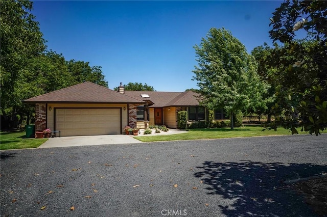 2787 Grape Way, Chico, CA 95973 - view of front of home featuring an attached garage, a chimney, a front yard, and driveway
