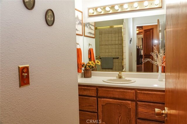2787 Grape Way, Chico, CA 95973 - bathroom with vanity, a textured wall, and a shower