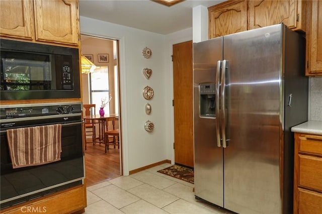 2787 Grape Way, Chico, CA 95973 - kitchen with black appliances, light tile patterned floors, light countertops, and brown cabinets