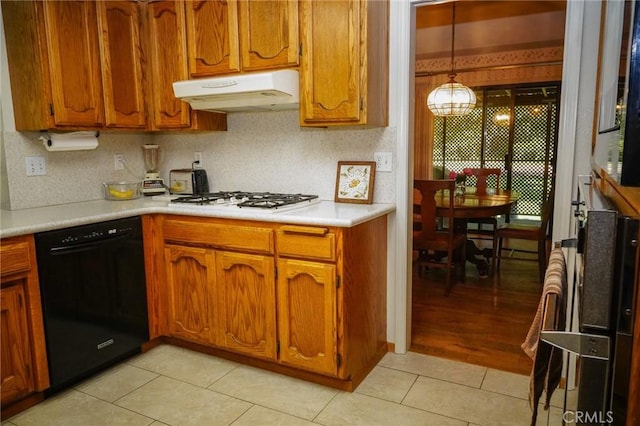 2787 Grape Way, Chico, CA 95973 - kitchen featuring black dishwasher, white gas cooktop, brown cabinets, under cabinet range hood, and light countertops
