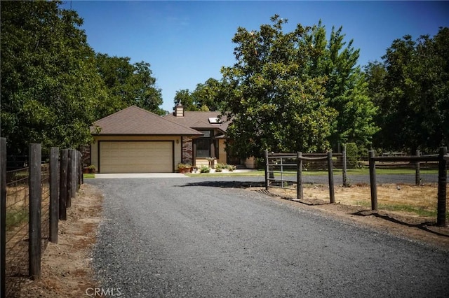 2787 Grape Way, Chico, CA 95973 - view of front of property featuring a garage, gravel driveway, and a chimney
