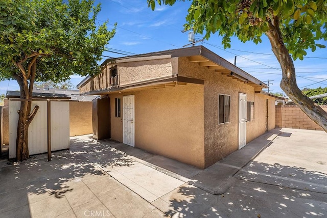 261 Twickenham Ave, Los Angeles, CA 90022 - view of home's exterior featuring stucco siding, a patio area, and an outdoor structure