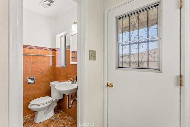 261 Twickenham Ave, Los Angeles, CA 90022 - half bathroom with tile walls and tile patterned floors