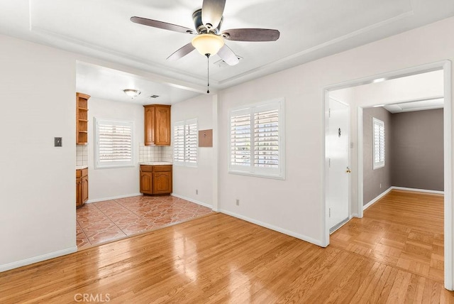 261 Twickenham Ave, Los Angeles, CA 90022 - spare room with a ceiling fan, light wood-type flooring, and a tray ceiling