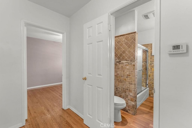 261 Twickenham Ave, Los Angeles, CA 90022 - bathroom featuring wood finished floors and enclosed tub / shower combo