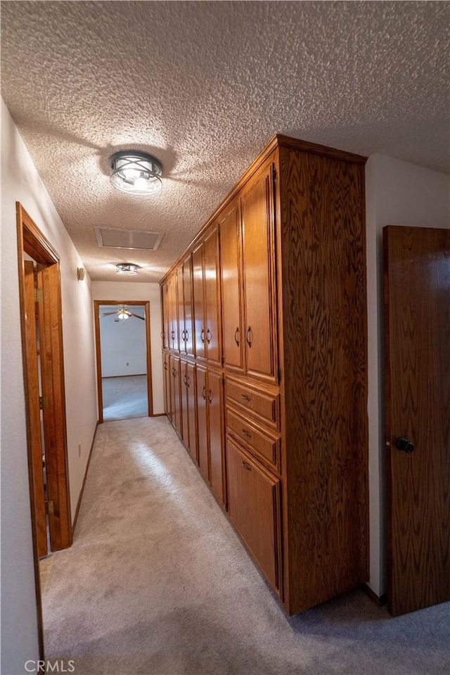 25967 Pleasant St, Hemet, CA 92544 - corridor with light colored carpet, a textured ceiling, and attic access