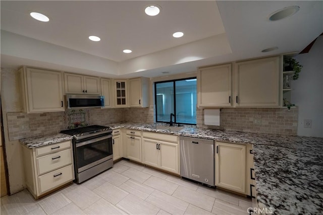 25967 Pleasant St, Hemet, CA 92544 - kitchen with appliances with stainless steel finishes, tasteful backsplash, open shelves, light stone counters, and cream cabinetry