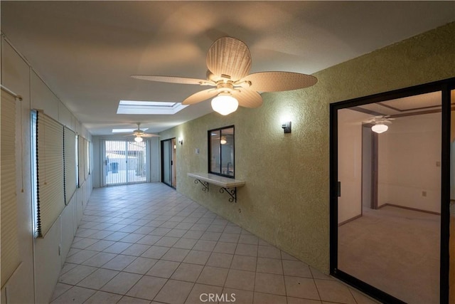 25967 Pleasant St, Hemet, CA 92544 - hall with a textured wall, a skylight, and light tile patterned flooring