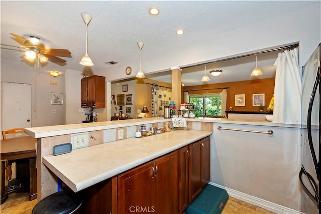 2734 Grove St, La Verne, CA 91750 - kitchen featuring light countertops, hanging light fixtures, ceiling fan, a peninsula, and recessed lighting