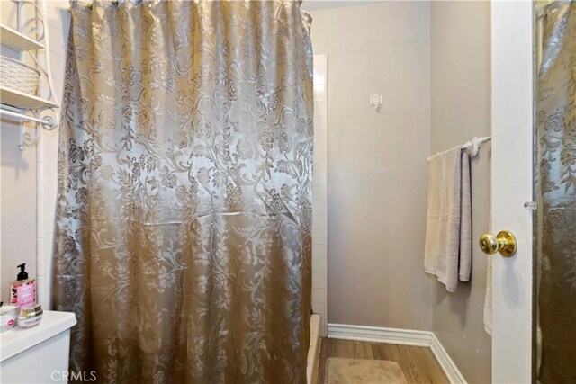 2734 Grove St, La Verne, CA 91750 - bathroom featuring wood finished floors and shower / bathtub combination with curtain