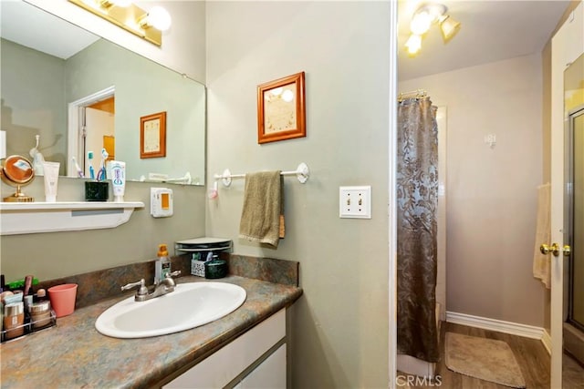 2734 Grove St, La Verne, CA 91750 - bathroom featuring vanity, curtained shower, and wood finished floors
